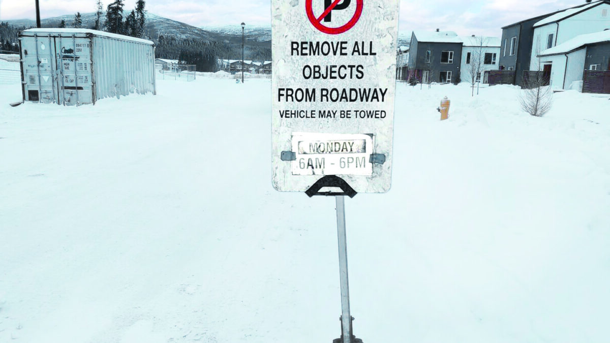 Sign saying 'No parking' with times for snow clearing