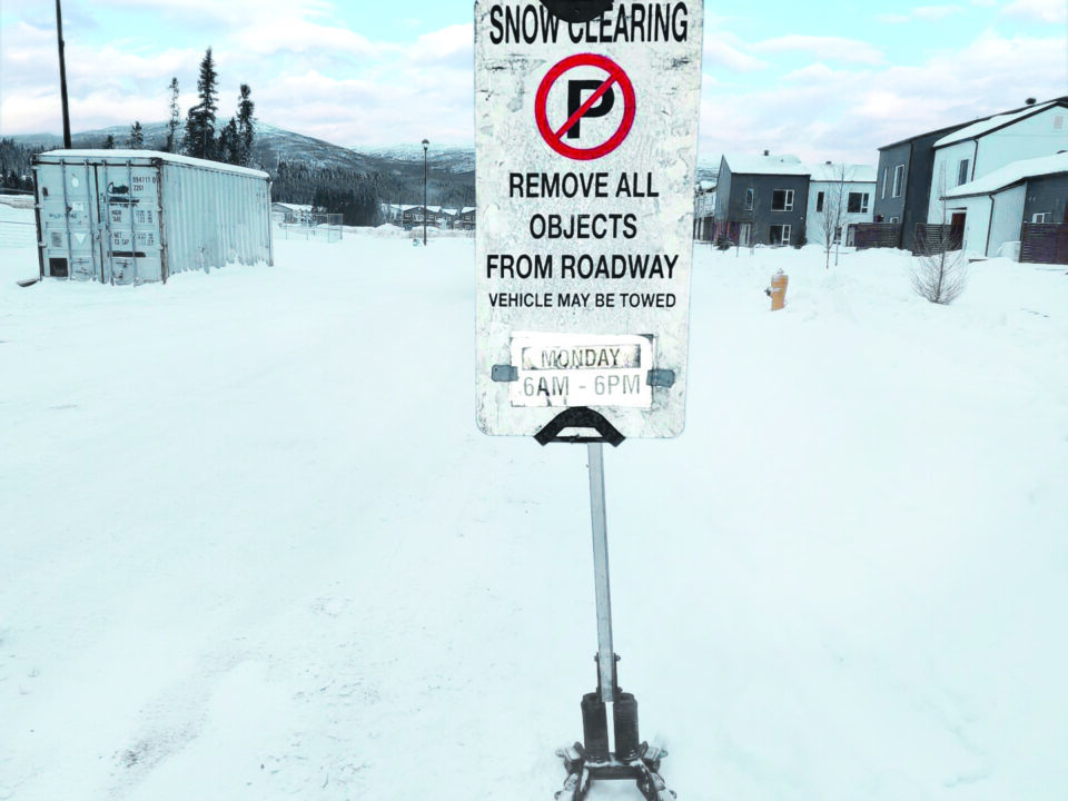 Sign saying 'No parking' with times for snow clearing